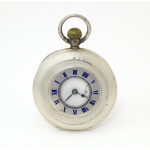 834 - An Omega half hunter silver pocket watch with blue enamel numerals  and engine turned decoration. Th... 