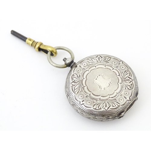 839 - A Continental .935 silver fob watch with engraved decoration and white enamel dial with gilt highlig... 