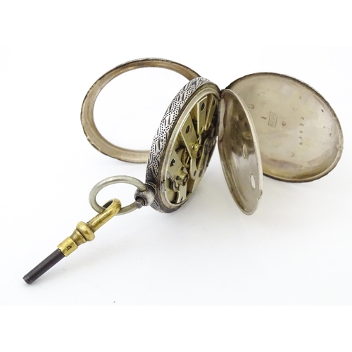 839 - A Continental .935 silver fob watch with engraved decoration and white enamel dial with gilt highlig... 