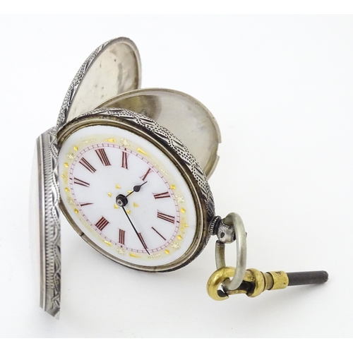 839 - A Continental .935 silver fob watch with engraved decoration and white enamel dial with gilt highlig... 