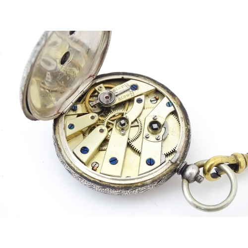 839 - A Continental .935 silver fob watch with engraved decoration and white enamel dial with gilt highlig... 