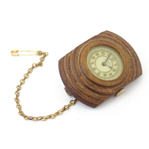 842 - An unusual watch formed as a brooch, the Siro watch with 15 jewel movement mounted within a carved w... 