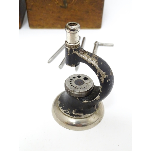 851 - Watchmakers / Repairers Equipment : Two cased watchmaker's staking tools / punches. One marked Ges C... 