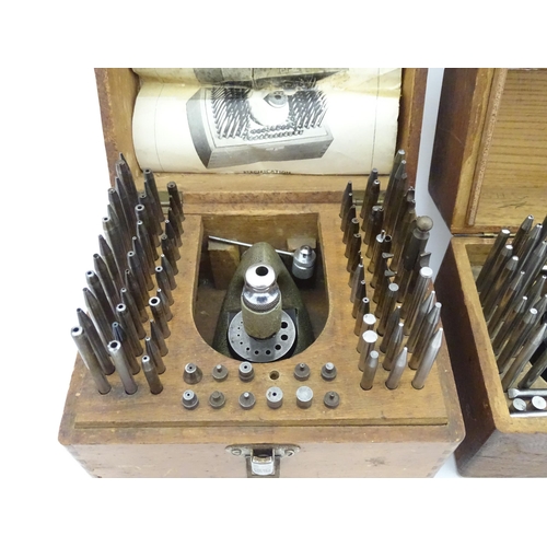 851 - Watchmakers / Repairers Equipment : Two cased watchmaker's staking tools / punches. One marked Ges C... 