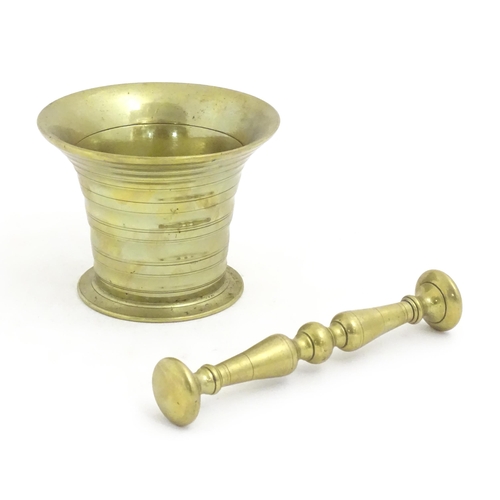 1198 - A 19thC cast brass pestle and mortar with banded detail. Approx. 3 1/2