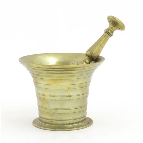 1198 - A 19thC cast brass pestle and mortar with banded detail. Approx. 3 1/2