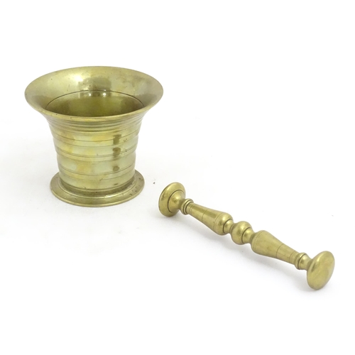 1198 - A 19thC cast brass pestle and mortar with banded detail. Approx. 3 1/2