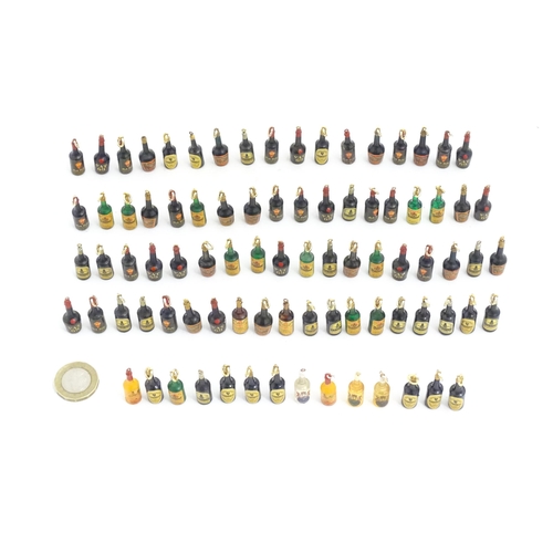 1200 - A quantity of 20thC pendant charms / fobs modelled as miniature bottles of alcohol, to include Guinn... 