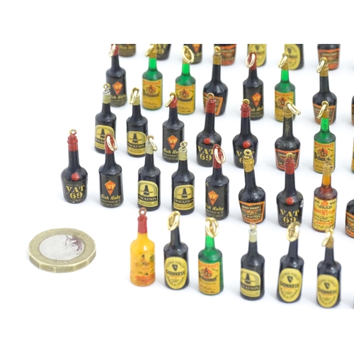 1200 - A quantity of 20thC pendant charms / fobs modelled as miniature bottles of alcohol, to include Guinn... 