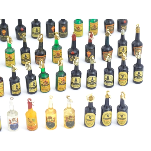 1200 - A quantity of 20thC pendant charms / fobs modelled as miniature bottles of alcohol, to include Guinn... 