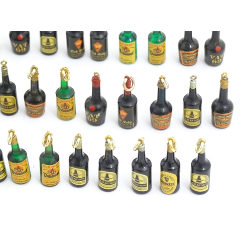 1200 - A quantity of 20thC pendant charms / fobs modelled as miniature bottles of alcohol, to include Guinn... 