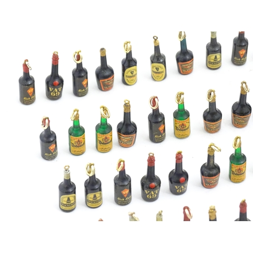 1200 - A quantity of 20thC pendant charms / fobs modelled as miniature bottles of alcohol, to include Guinn... 