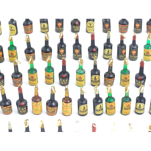 1200 - A quantity of 20thC pendant charms / fobs modelled as miniature bottles of alcohol, to include Guinn... 