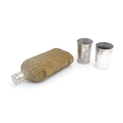 1201 - A 20thC wicker covered glass bottle. Together with two silver plate beakers by Mappin & Webb. Bottle... 