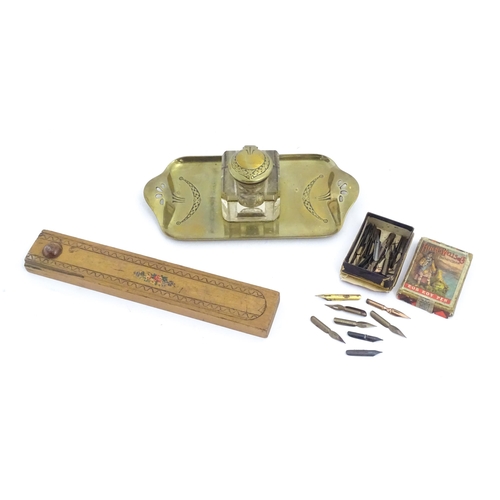 1219 - A 20thC cast brass desk standish, the central glass inkwell flanked by engraved swag decoration and ... 