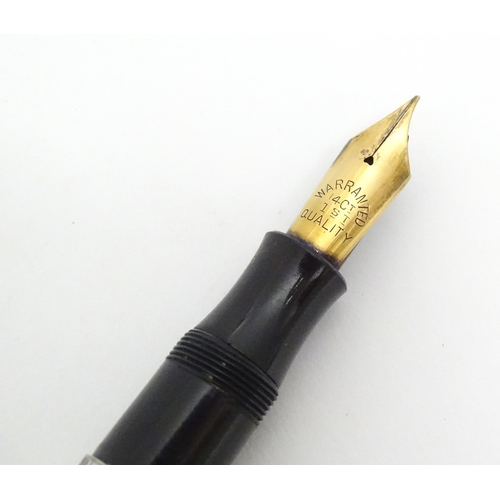 1222 - A mid 20thC white metal fountain pen, the clip indistinctly stamped, fitted with a 14CT gold nib. Ap... 