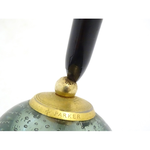 1228 - A 20thC Parker pen holder formed as a Whitefriars style glass paperweight. Approx. 9