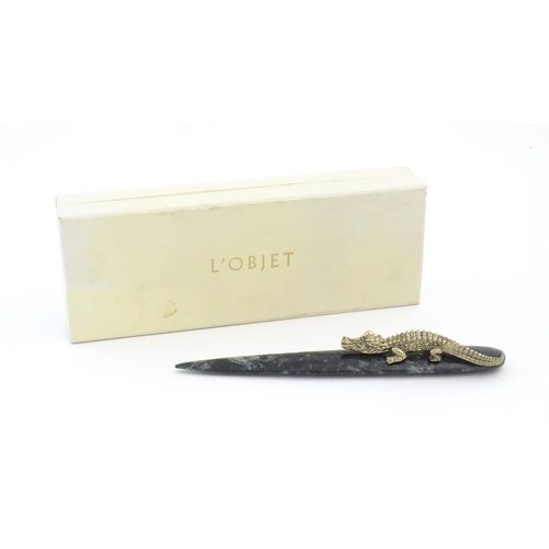 1231 - A 20thC novelty serpentine hardstone paperknife / letter opener / page turner surmounted by a model ... 