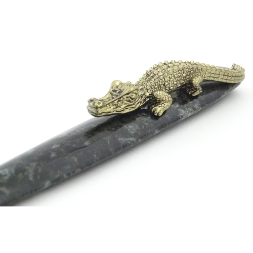 1231 - A 20thC novelty serpentine hardstone paperknife / letter opener / page turner surmounted by a model ... 