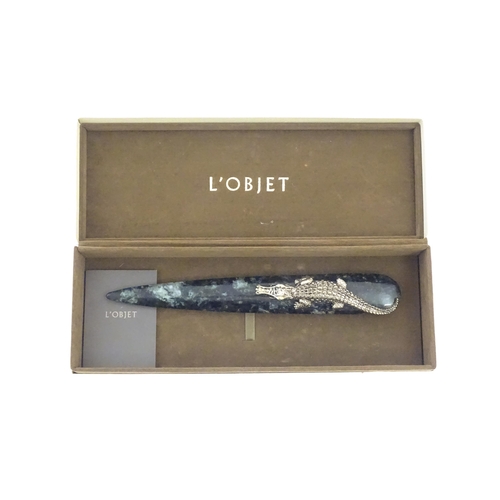 1231 - A 20thC novelty serpentine hardstone paperknife / letter opener / page turner surmounted by a model ... 