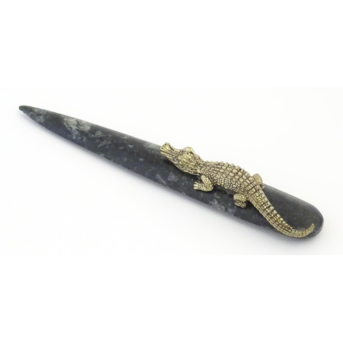 1231 - A 20thC novelty serpentine hardstone paperknife / letter opener / page turner surmounted by a model ... 