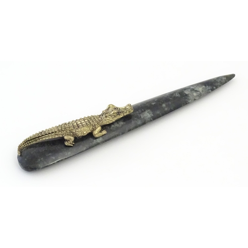 1231 - A 20thC novelty serpentine hardstone paperknife / letter opener / page turner surmounted by a model ... 