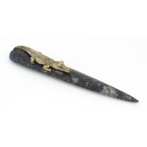 1231 - A 20thC novelty serpentine hardstone paperknife / letter opener / page turner surmounted by a model ... 