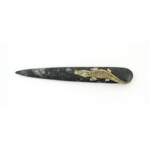 1231 - A 20thC novelty serpentine hardstone paperknife / letter opener / page turner surmounted by a model ... 