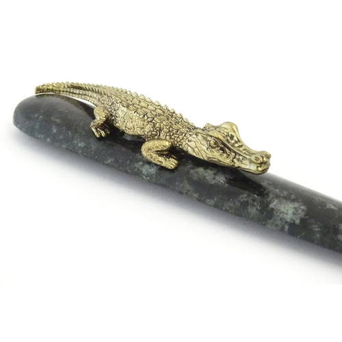 1231 - A 20thC novelty serpentine hardstone paperknife / letter opener / page turner surmounted by a model ... 