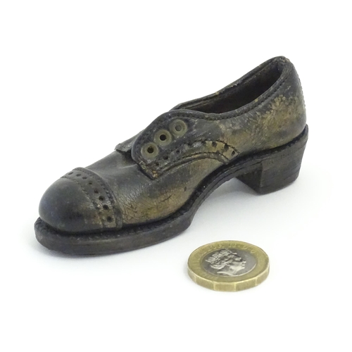 1239 - An early 20thC cobbler's apprentice piece model of a shoe. Approx. 3 3/4