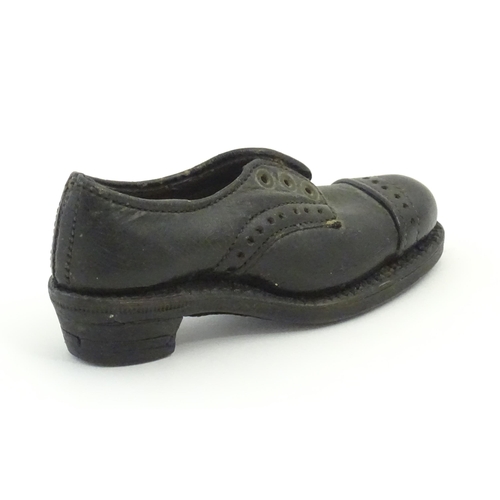 1239 - An early 20thC cobbler's apprentice piece model of a shoe. Approx. 3 3/4