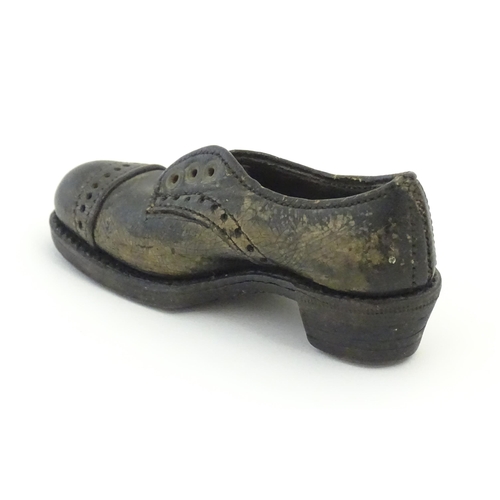 1239 - An early 20thC cobbler's apprentice piece model of a shoe. Approx. 3 3/4