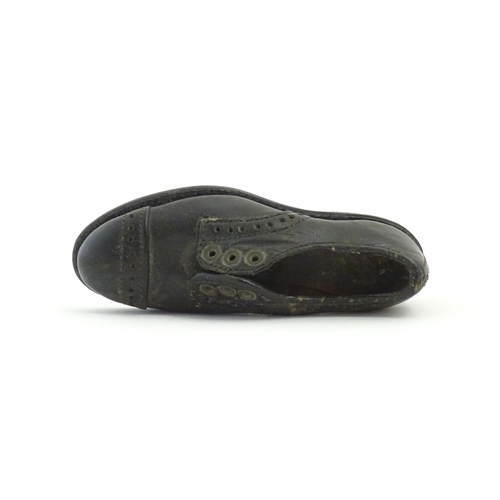 1239 - An early 20thC cobbler's apprentice piece model of a shoe. Approx. 3 3/4