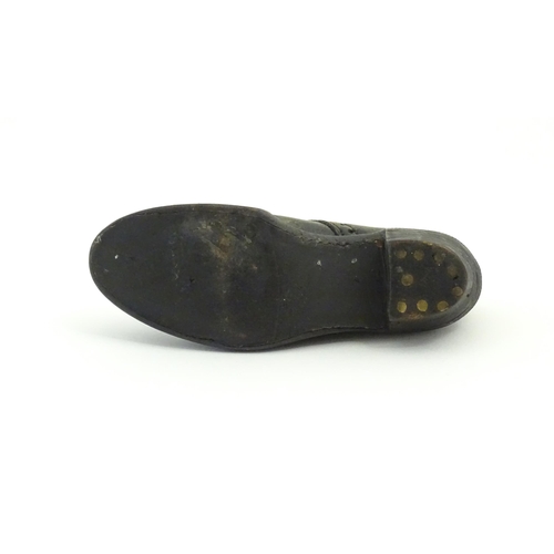 1239 - An early 20thC cobbler's apprentice piece model of a shoe. Approx. 3 3/4