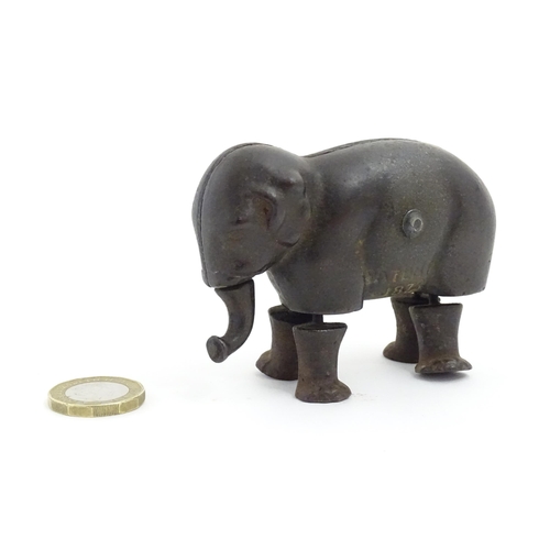 1464 - Toy: A late 19thC cast iron walking elephant toy with articulated legs and trunk, by the Ives Toy Co... 