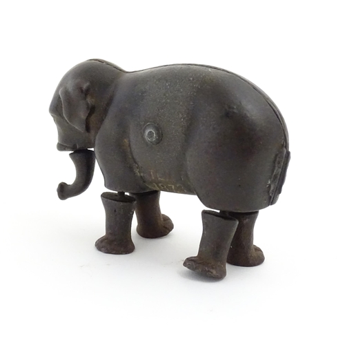 1464 - Toy: A late 19thC cast iron walking elephant toy with articulated legs and trunk, by the Ives Toy Co... 