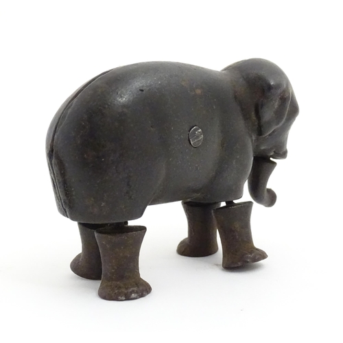 1464 - Toy: A late 19thC cast iron walking elephant toy with articulated legs and trunk, by the Ives Toy Co... 