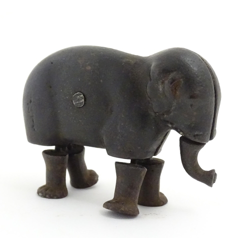 1464 - Toy: A late 19thC cast iron walking elephant toy with articulated legs and trunk, by the Ives Toy Co... 