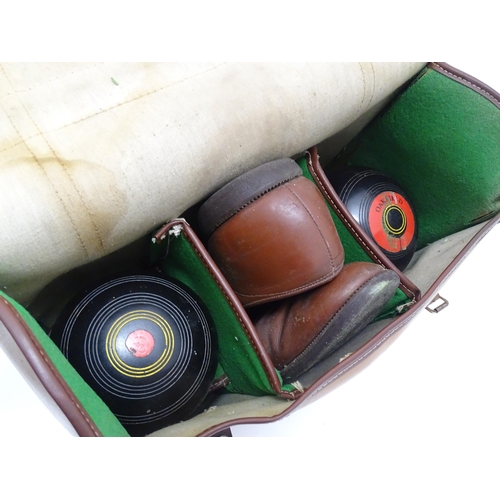 1312 - Lawn Bowls Interest: Four 20thC lawn bowls, a pair of lawn bowls shoes and a Terry Bowls Measure. Co... 