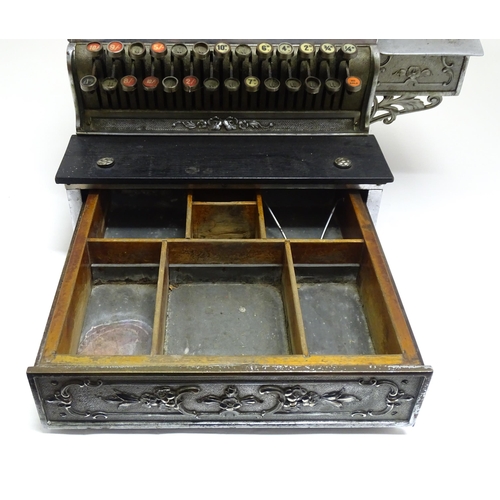 1316 - An early 20thC American cash register with floral and foliate decoration, by the National Cash Regis... 