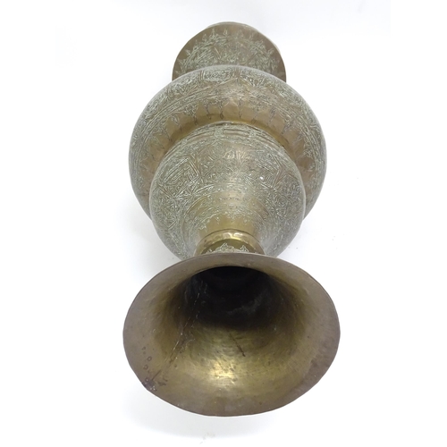 1317 - A large Eastern brass double gourd style vase flared foot and rim with engraved decoration. Approx. ... 