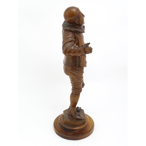 1321 - An early 20thC carved walnut figure modelled as a Pierrot, possibly the French mime artist and actor... 