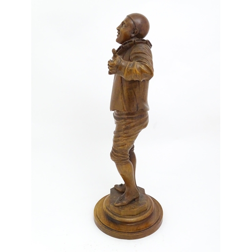 1321 - An early 20thC carved walnut figure modelled as a Pierrot, possibly the French mime artist and actor... 