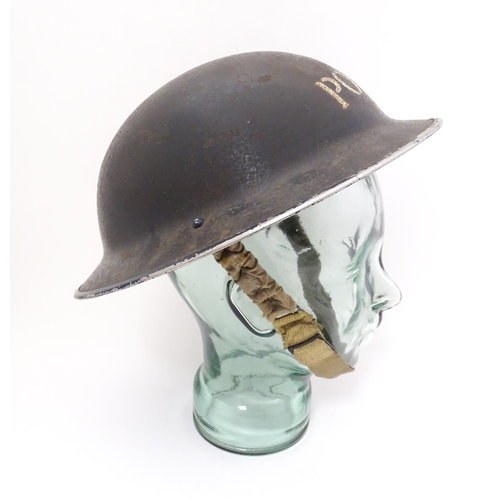 858 - Militaria , WWII / World War 2 / WW2 / Second World War : a steel brodie helmet in Police livery, wi... 