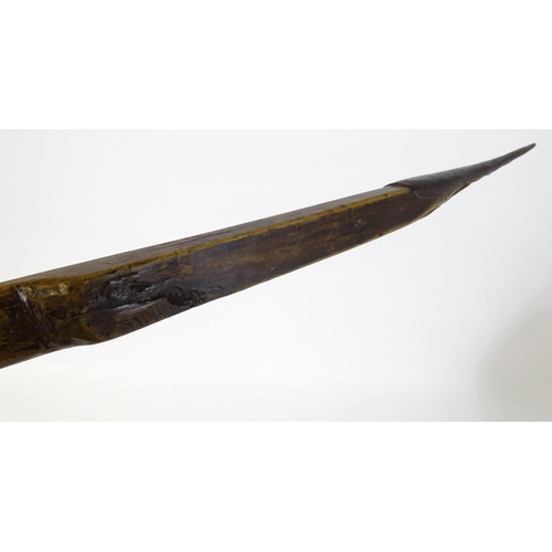 868 - Arms / Armour : A longbow or section of a crossbow of carved form with applied iron tapering mounts ... 