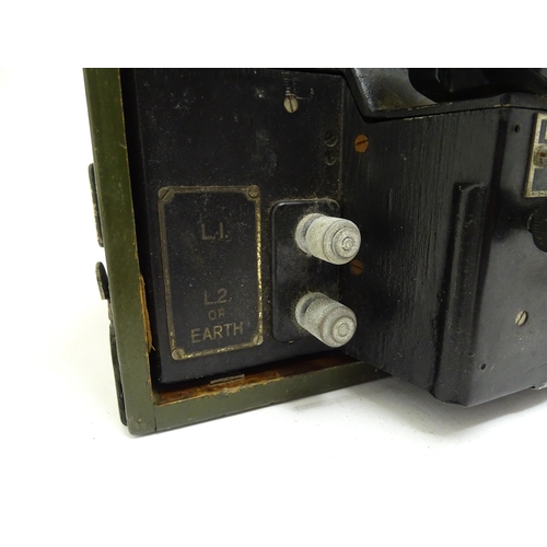 869 - Militaria : a 20thC British Army field telephone, produced by General Electric, in black finish, the... 