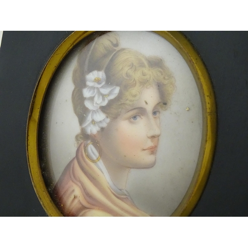 1266 - A 20thC oval watercolour and bodycolour portrait miniature depicting a young lady with flowers in he... 