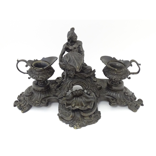 1295 - A cast desk standish in the Renaissance style with central merman flanked by two inkwells, and shell... 