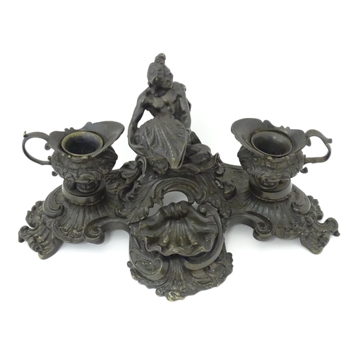 1295 - A cast desk standish in the Renaissance style with central merman flanked by two inkwells, and shell... 