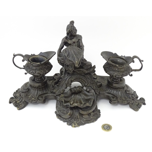 1295 - A cast desk standish in the Renaissance style with central merman flanked by two inkwells, and shell... 